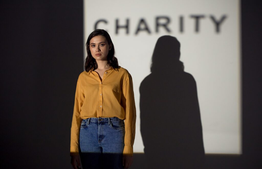woman standing in front of charity sign